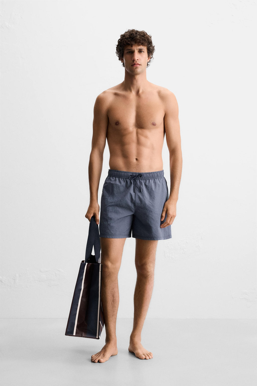 STRIPED MID-LENGTH SWIMMING TRUNKS