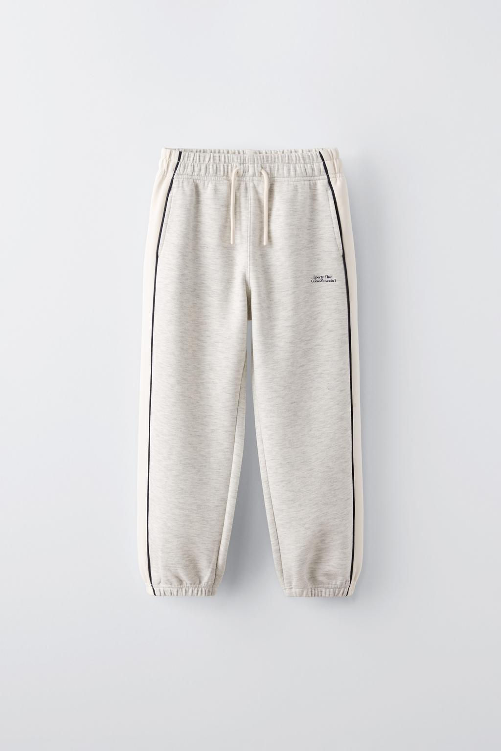 TROUSERS WITH CONTRAST PIPED STRIPES